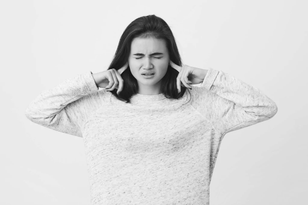 woman plugging ears