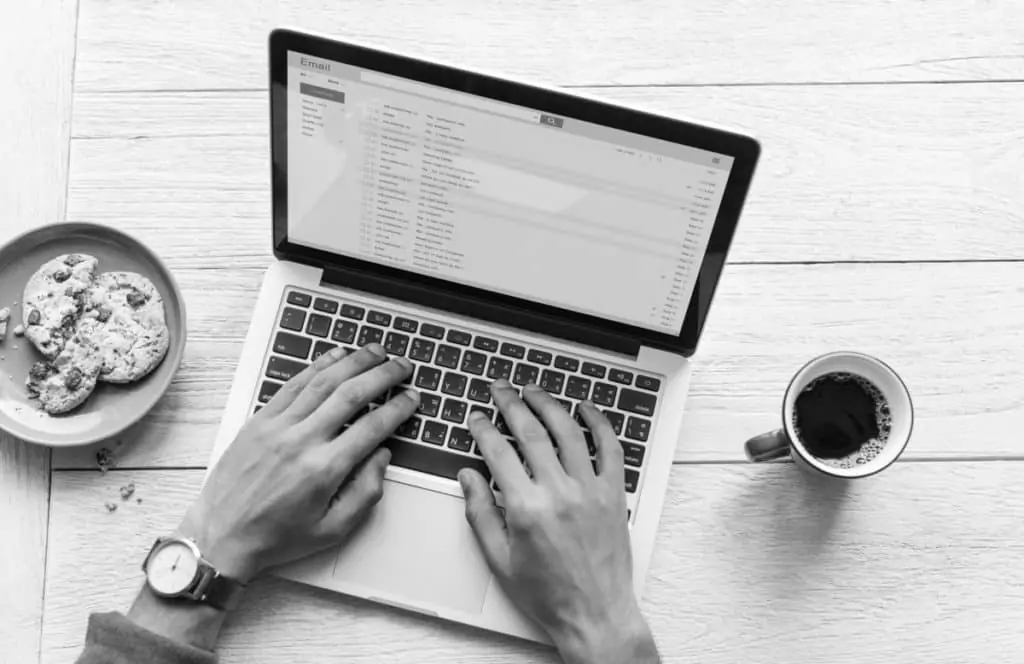 internal email security person typing on laptop